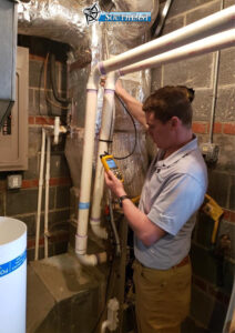 Zach measuring the ‘static pressure’ of a duct system